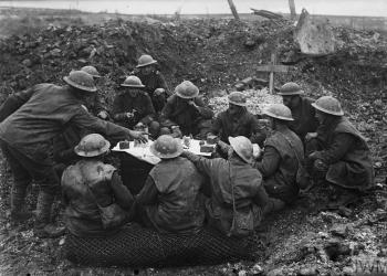 CHRISTMAS ON THE WESTERN FRONT, 1914-1918 (Q 1631) British troops eating their Christmas dinner in a shell hole, Beaumont Hamel, 25th December 1916 Copyright: © IWM. Original Source: http://www.iwm.org.uk/collections/item/object/205072886