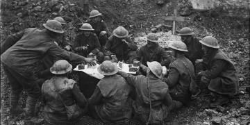 CHRISTMAS ON THE WESTERN FRONT, 1914-1918 (Q 1631) British troops eating their Christmas dinner in a shell hole, Beaumont Hamel, 25th December 1916 Copyright: © IWM. Original Source: http://www.iwm.org.uk/collections/item/object/205072886