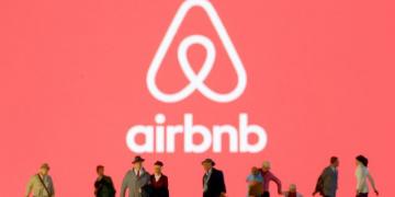 FILE PHOTO: Small toy figures are seen in front of diplayed Airbnb logo in this illustration taken March 19, 2020. REUTERS/Dado Ruvic/Illustration/File Photo