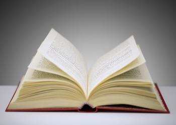 Close up of open book on counter