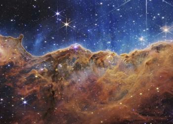 This image released by NASA on Tuesday, July 12, 2022, shows the edge of a nearby, young, star-forming region NGC 3324 in the Carina Nebula. Captured in infrared light by the Near-Infrared Camera (NIRCam) on the James Webb Space Telescope, this image reveals previously obscured areas of star birth, according to NASA. (NASA, ESA, CSA, and STScI via AP)