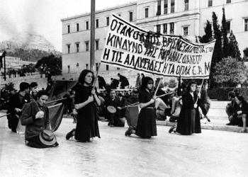 After six weeks of fighting between rival political groups, police, and British troops who were brought in to quell the disorders, the E.L.A.S. guerrillas are gradually being pushed out of their Athens strongholds by General Scobie’s men. These pictures – from the E.L.A.S. side – show street scenes during the clash between Athens police and E.L.A.S. demonstrators on December 3, and the mourning of relatives of those killed during the clash. A funeral procession, carrying a banner painted with the blood of dead demonstrators in Athens on Dec. 4, 1944, pauses opposite the Old Royal Palace, which was the scene of the clash with the police the day before, as a band plays a Russian Revolutionary Funeral March. (AP Photo)