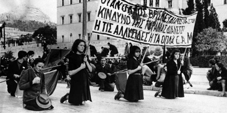 After six weeks of fighting between rival political groups, police, and British troops who were brought in to quell the disorders, the E.L.A.S. guerrillas are gradually being pushed out of their Athens strongholds by General Scobie’s men. These pictures – from the E.L.A.S. side – show street scenes during the clash between Athens police and E.L.A.S. demonstrators on December 3, and the mourning of relatives of those killed during the clash. A funeral procession, carrying a banner painted with the blood of dead demonstrators in Athens on Dec. 4, 1944, pauses opposite the Old Royal Palace, which was the scene of the clash with the police the day before, as a band plays a Russian Revolutionary Funeral March. (AP Photo)