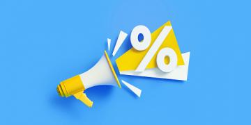 Percentage sign coming out from a yellow megaphone on blue background. Horizontal composition with copy space. Great use for sale and percent concepts.