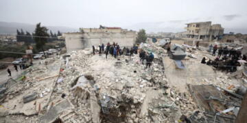 epa10450732 Rescuers work at the site of a collapsed building following an earthquake in Armanaz town, Idlib Governorate, Syria 06 February 2023. According to the US Geological Service, an earthquake with a preliminary magnitude of 7.8 struck southern Turkey close to the Syrian border, causing buildings to collapse and sending shockwaves over northwest Syria, Cyprus, and Lebanon. At least 221 people were killed and 419 injured in northwest Syria, with hundreds remaining trapped under the rubble, according to the White Helmets group, the Syria Civil Defence operating in the area.  EPA/YAHYA NEMAH