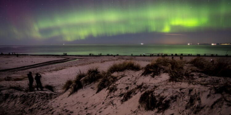 epa10495230 Northern Lights (Aurora Borealis) illuminate the sky over Hornbaek beach, on the coast of North Zealand, Denmark, late 27 February 2023 (issued 28 February 2023).  EPA/MADS CLAUS RASMUSSEN DENMARK OUT