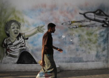 epa10557338 A Yemeni passes graffiti sprayed on a wall depicting a child victim of Yemen's war, on the first anniversary of a UN-brokered truce, in Sana'a, Yemen, 03 April 2023. Yemen continues to experience its longest lull in fighting since the UN-brokered truce between the Yemeni government and the Houthis started on 02 April 2022, despite the warring parties failure to renew the truce in October 2022. Yemen’s war is referred to as the Saudi Arabia-Iran proxy conflict in which the warring parties have been militarily and politically backed by Saudi Arabia and Iran respectively since 2015.  EPA/YAHYA ARHAB