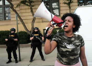 Members of the Sheriff's department stand in riot gear as demonstrators gather outside Akron City Hall to protest the killing of Jayland Walker, shot by police, in Akron, Ohio, July 3, 2022. - Several hundred protesters marched Sunday in Akron, Ohio after the release of body camera footage that showed police fatally shooting a Black man with several dozen rounds of bullets.As anger rose over the latest police killing of a Black man in the United States, and authorities appealed for calm, a crowd marched to City Hall carrying banners with slogans such as "Justice for Jayland." (Photo by Matthew Hatcher / AFP) (Photo by MATTHEW HATCHER/AFP via Getty Images)