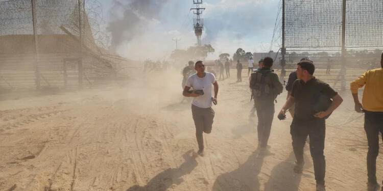 Palestinians take down the fence on the Israel-Gaza border to enter Israel during the surprise attack on Oct. 7. HANI ALSHAER/ANADOLU AGENCY VIA GETTY IMAGES